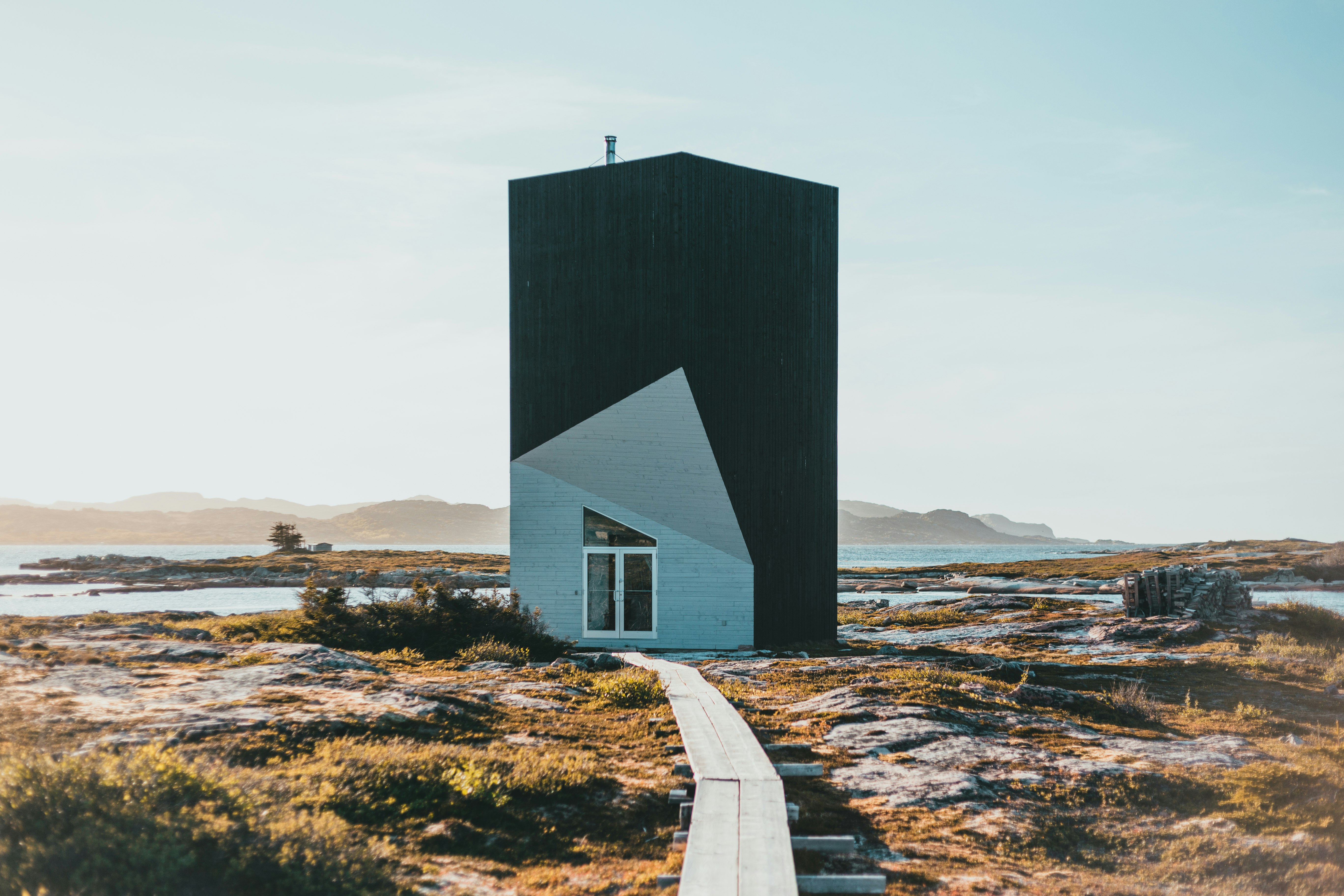 black and white wooden house on brown field during daytime